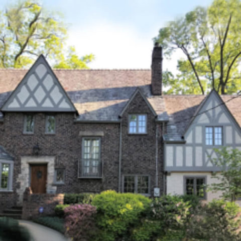 A brick house with glass windows in Ridgewood
