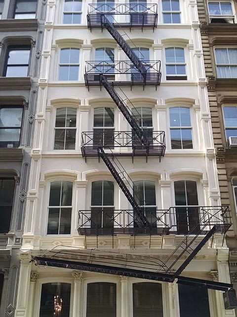 apartment building with fire escape stairs in manhattan