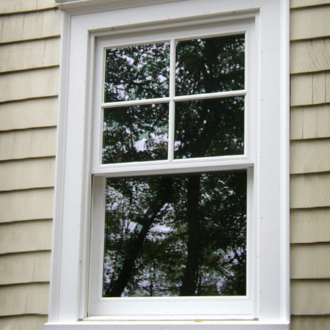White-framed double-hung window in Port Jefferson by HS Windows.