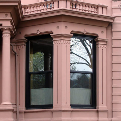 Ornate bay windows with black frames in Brooklyn by HS Windows.